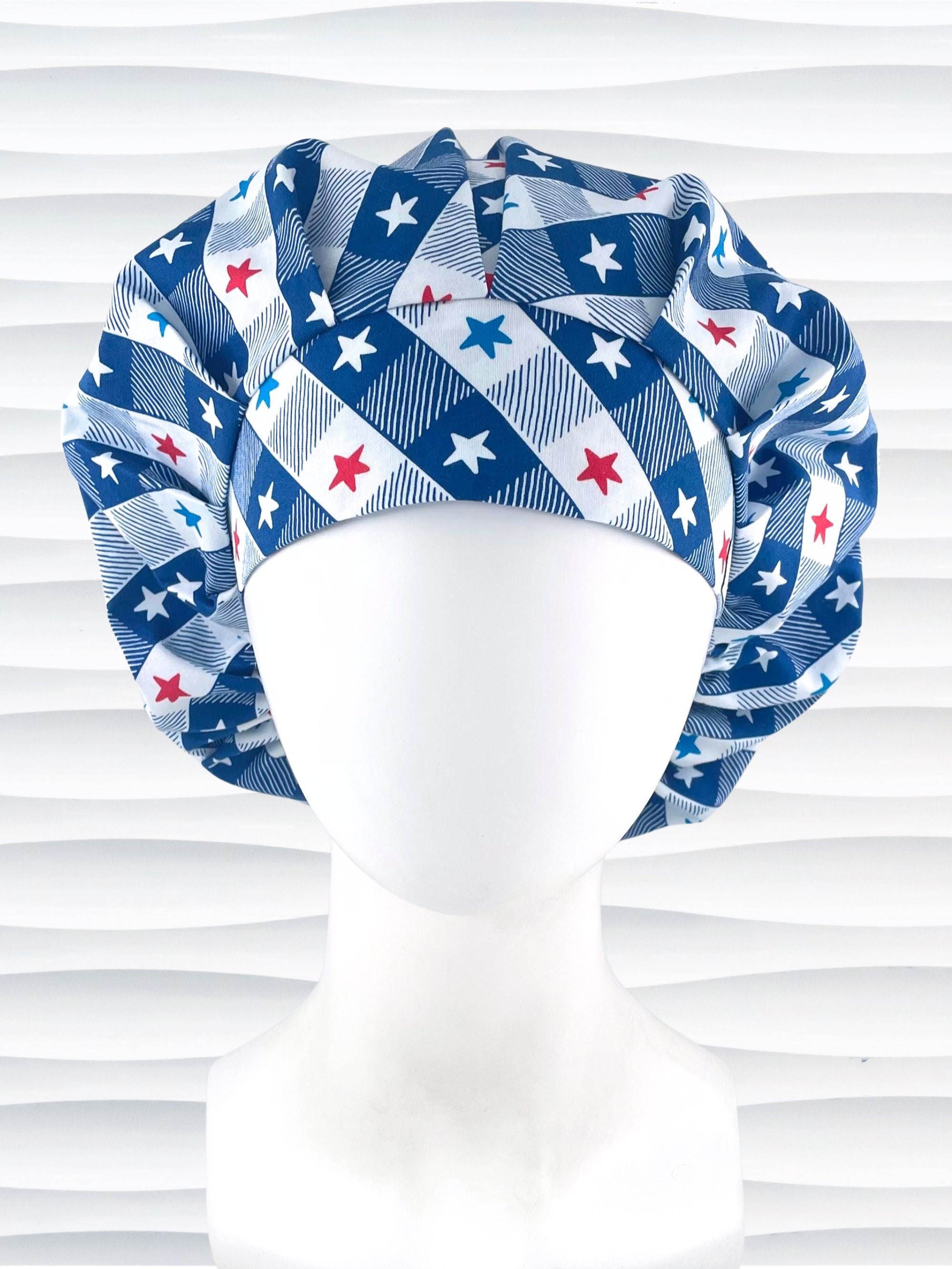 Bouffant style surgical scrub cap with patriotic stars in red white and blue in a modern blue and white buffalo plaid pattern on cotton fabric.