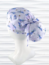 Ponytail pouch style surgical scrub cap hat with blue and purple dragonflies and honey bees all over lavender background cotton fabric.
