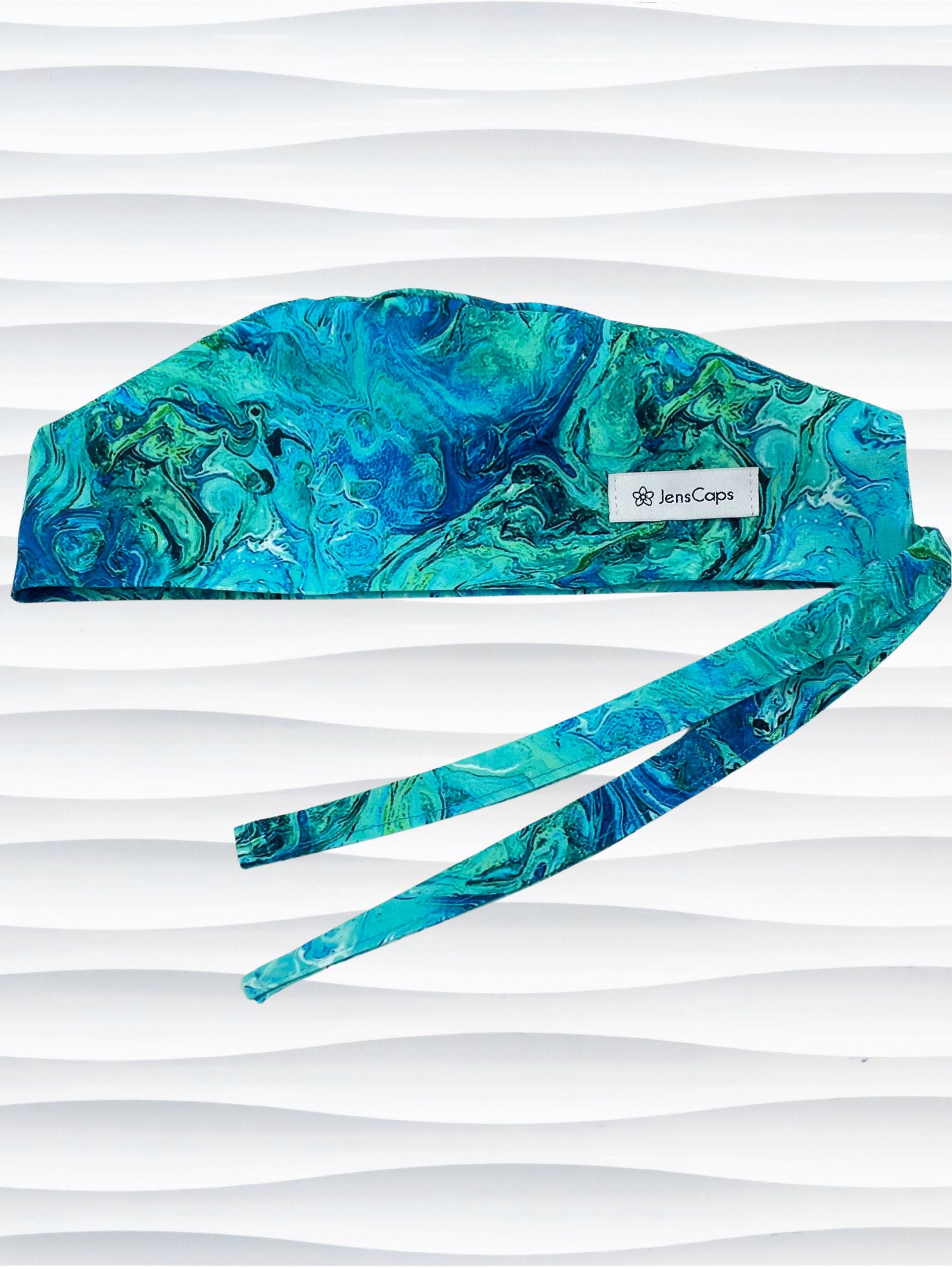 Surgeon style surgical scrub cap by JensCaps with green and blue abstract patterns like an oil slick or turquoise marble all over this cotton fabric.