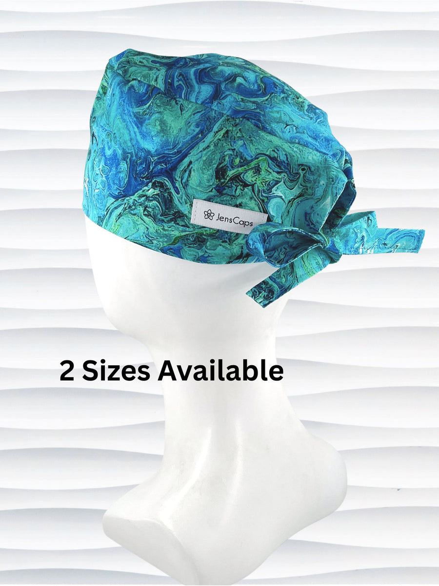 Surgeon style surgical scrub cap by JensCaps with green and blue abstract patterns like an oil slick or turquoise marble all over this cotton fabric.