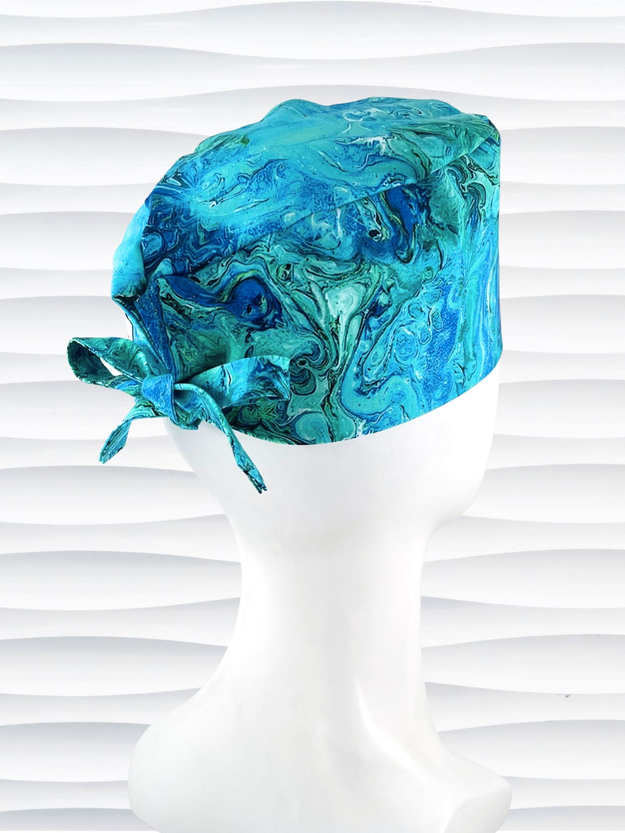 Surgeon style surgical scrub cap by JensCaps with green and blue abstract patterns like an oil slick or turquoise marble all over this cotton fabric.
