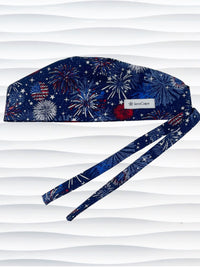 Surgeon style surgical scrub cap by JensCaps with fireworks and stars in red white and blue all over navy blue cotton fabric.