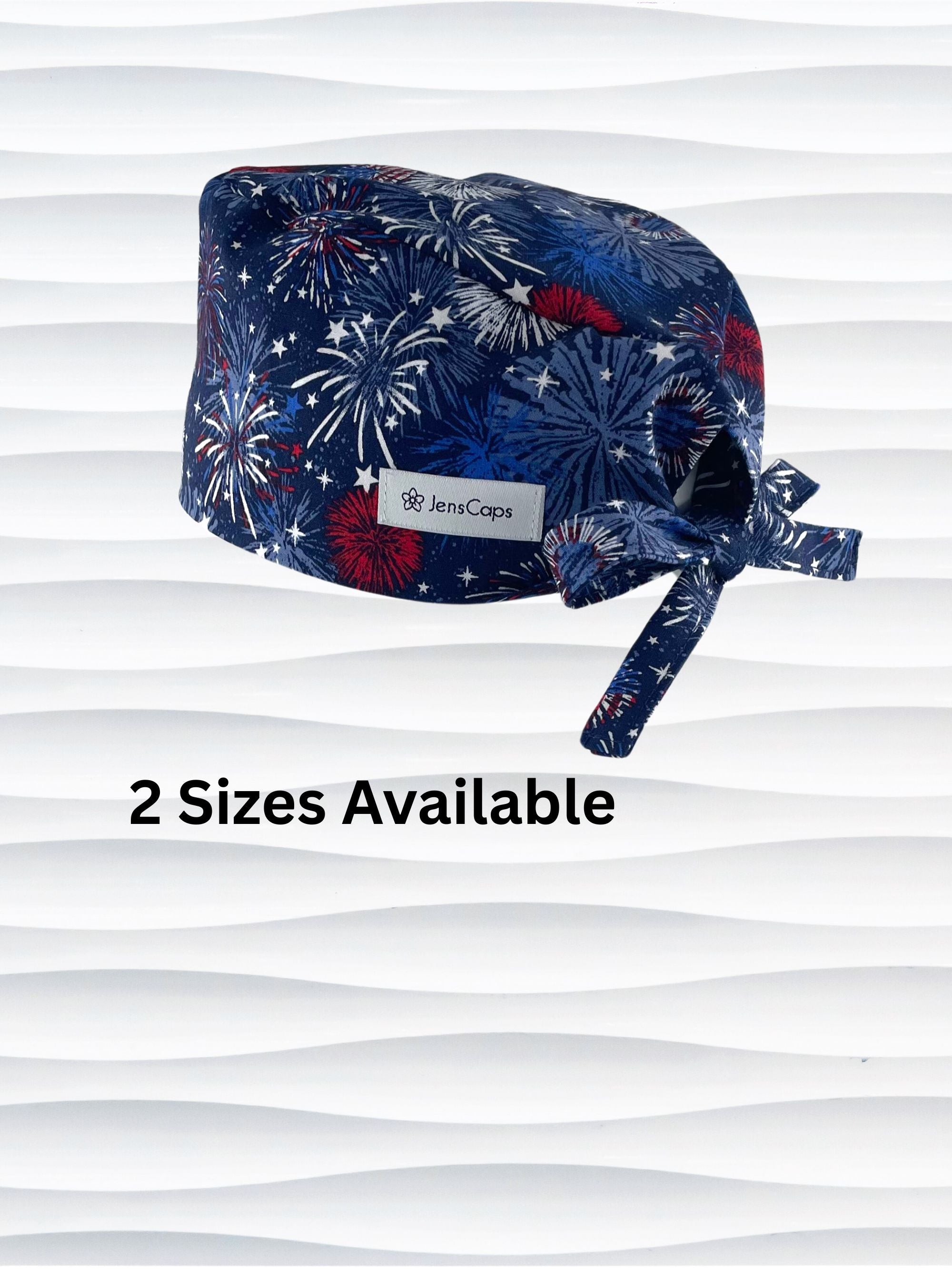 Surgeon style surgical scrub cap by JensCaps with fireworks and stars in red white and blue all over navy blue cotton fabric.