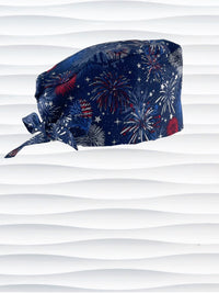 Surgeon style surgical scrub cap by JensCaps with fireworks and stars in red white and blue all over navy blue cotton fabric.