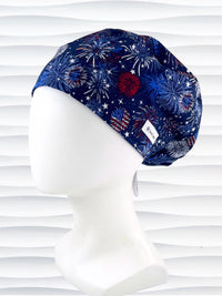 Euro Pixie style surgical scrub cap by JensCaps with fireworks and stars in red white and blue all over navy blue cotton fabric.