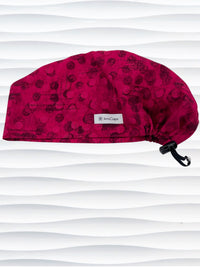 Euro Pixie style surgical scrub cap with a muted pattern of black circles and lines on deep red or magenta cotton fabric.