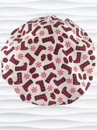 Bouffant style surgical scrub cap with snowflakes and red and black buffalo check winter boots and mittens on cotton fabric.