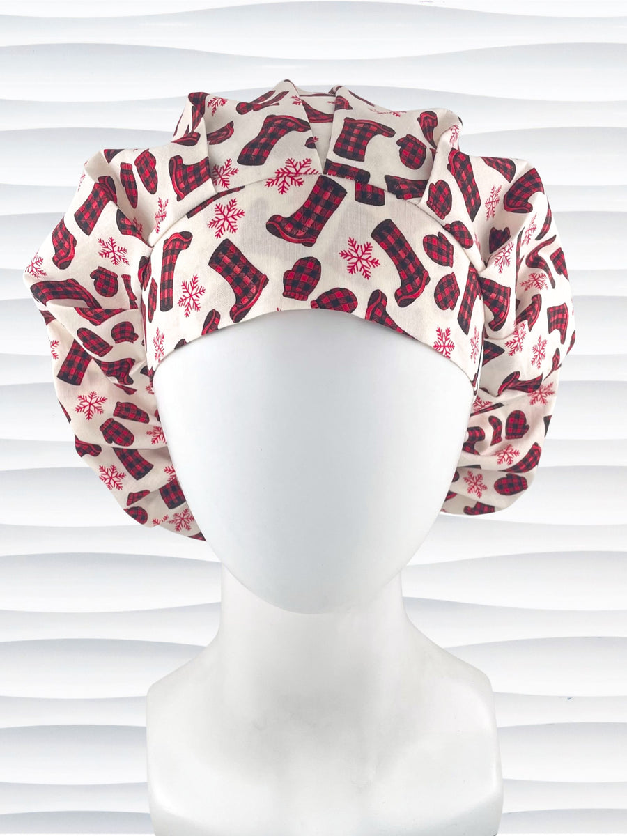Bouffant style surgical scrub cap with snowflakes and red and black buffalo check winter boots and mittens on cotton fabric.