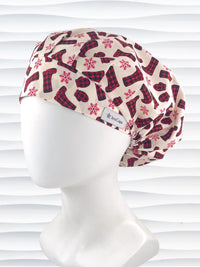 Bouffant style surgical scrub cap with snowflakes and red and black buffalo check winter boots and mittens on cotton fabric.
