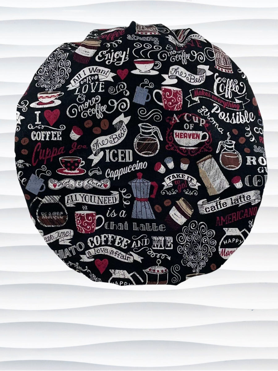 Bouffant style surgical scrub cap hat with words describing coffee icons and coffee cups and mugs in white and burgundy on black cotton fabric.