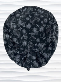 Euro Pixie style surgical scrub cap by JensCaps with silver outlines of lemons, lemon leaves, and lemon slices all over a black background and displayed on a white mannequin head.