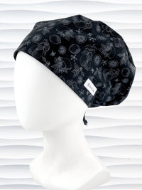 Euro Pixie style surgical scrub cap by JensCaps with silver outlines of lemons, lemon leaves, and lemon slices all over a black background and displayed on a white mannequin head.