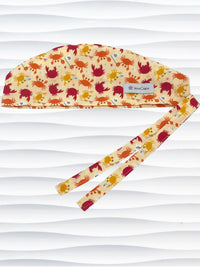 Colorful crab print surgical scrub cap featuring orange, red, and yellow cartoon crabs on cream fabric, displayed on mannequin head – handmade nurse and doctor scrub hat by JensCaps
