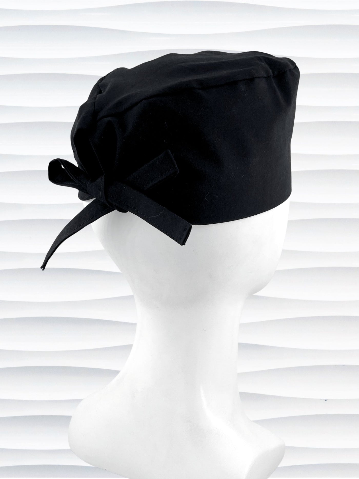 Surgeon style surgical scrub cap with solid black premium cotton and shown on white mannequin head