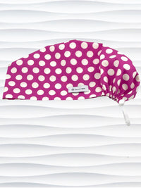 Euro Pixie style surgical scrub cap with large white dots on raspberry colored cotton fabric.