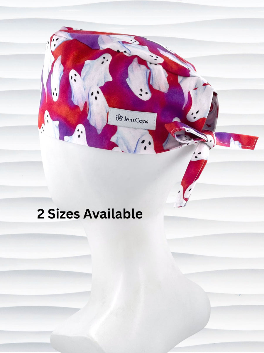 Surgeon style surgical scrub cap by JensCaps with white sheet ghosts tossed all aver an ombre red and purple cotton fabric.