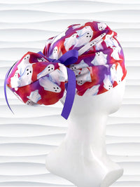 Euro Pony ponytail style surgical scrub cap by JensCaps with white sheet ghosts tossed all aver an ombre red and purple cotton fabric.