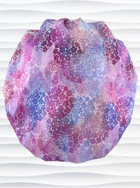 Bouffant style surgical scrub cap by JensCaps with small daisies in pink, blue, and purple all over cotton fabric and displayed on a mannequin head