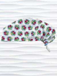 Euro Pixie style surgical scrub cap by JensCaps with red cherries blue polka dots on white cotton fabric and diplayed on a mannequin head.
