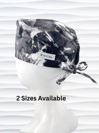 Mens surgeon tie back style surgical scrub cap in an abstract print in black and white on cotton fabric.