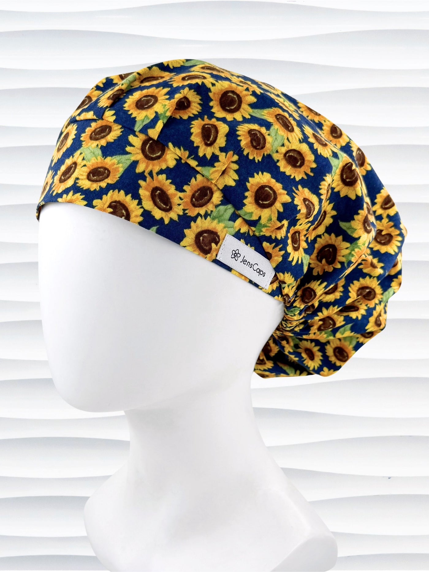 Bouffant style surgical scrub cap by jenscaps with sunflowers tossed all over a dark blue background cotton fabric