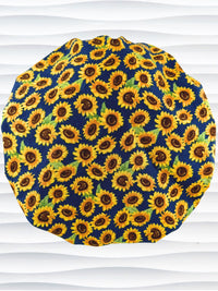 Bouffant style surgical scrub cap by jenscaps with sunflowers tossed all over a dark blue background cotton fabric