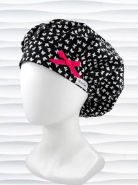 Bouffant surgical scrub cap by JensCaps with white butterflies all over black cotton fabric and shown with a hot pink bow on the front