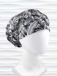 Bouffant style surgical scrub cap by JensCaps with black and white palm trees and displayed on a white mannequin head.