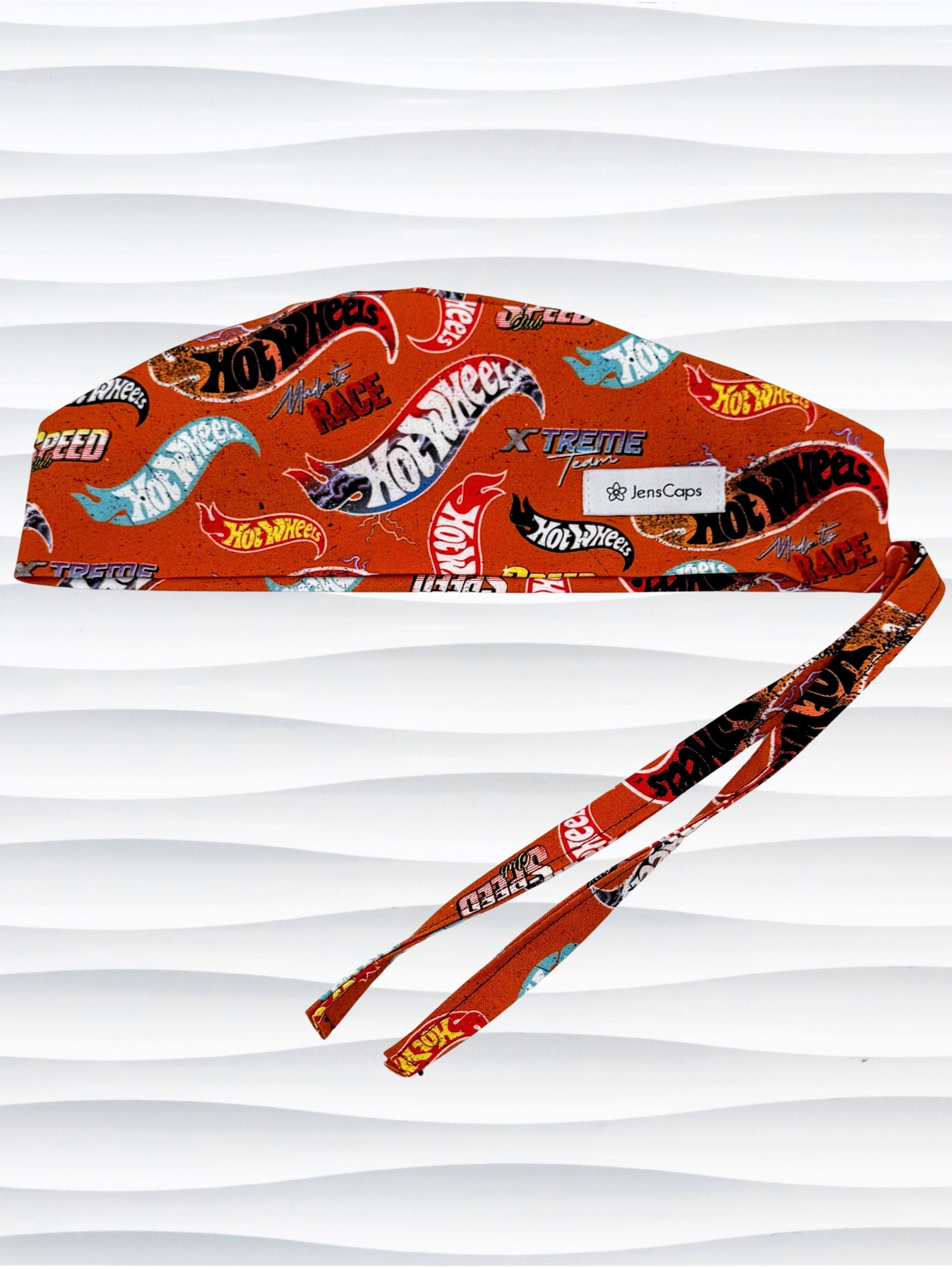 Surgeon style surgical scrub cap by JensCaps with dynamic car logos and flame details on an orange background 