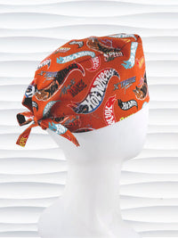 Surgeon style surgical scrub cap by JensCaps with dynamic car logos and flame details on an orange background displayed on a white mannequin head