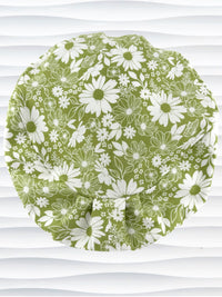 Euro Pixie style surgical scrub cap by JensCaps with white daisies and flowers all over a light green background cotton fabric and displayed on a mannequin head.