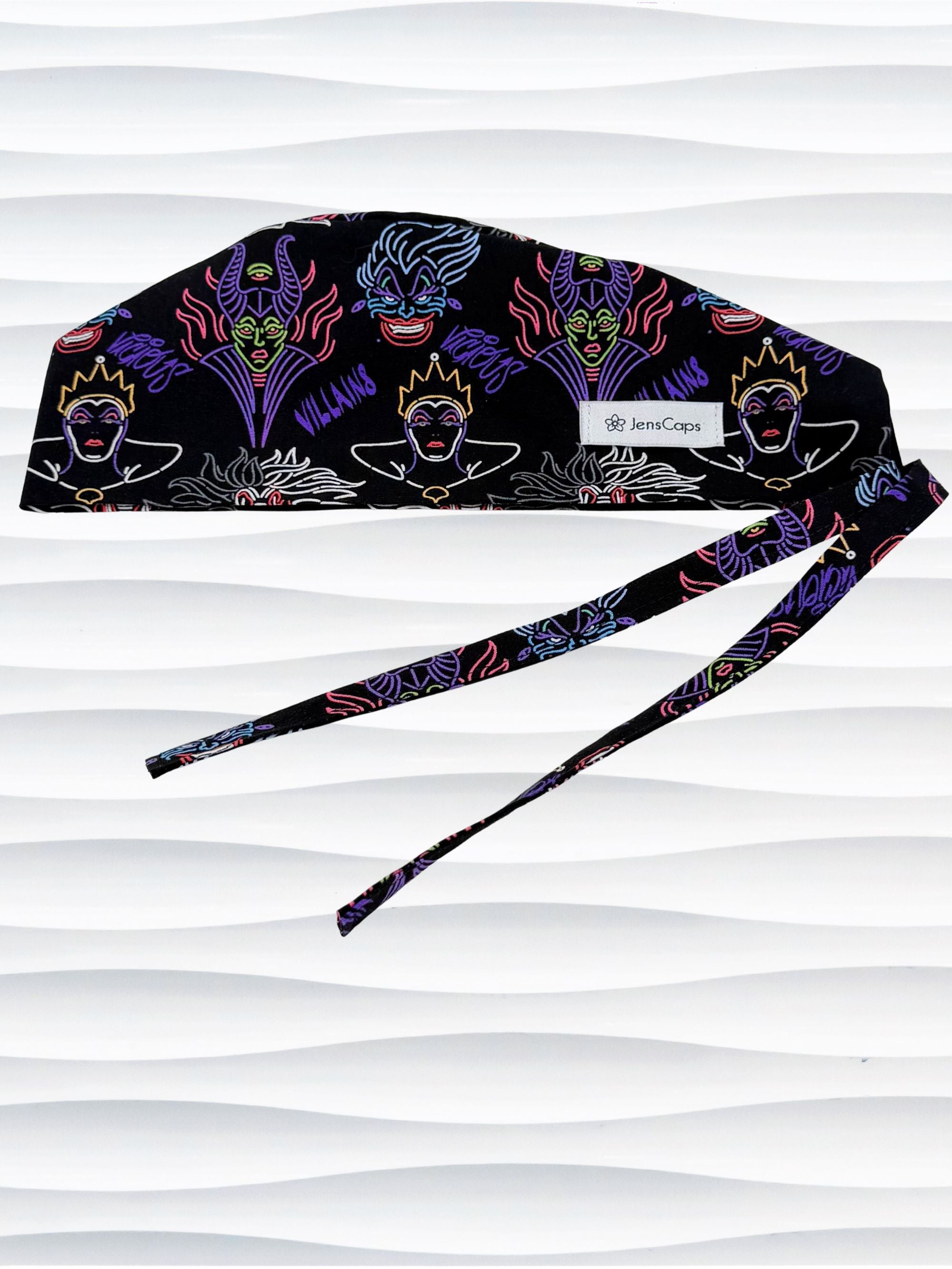Mens style surgical scrub skull cap with neon colors of iconic villains and queens all over black cotton fabric and displayed on mannequin head.