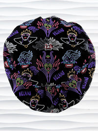 Euro Pixie style surgical scrub cap by JensCaps with neon colors of iconic villains all over black cotton fabric and displayed on mannequin head.