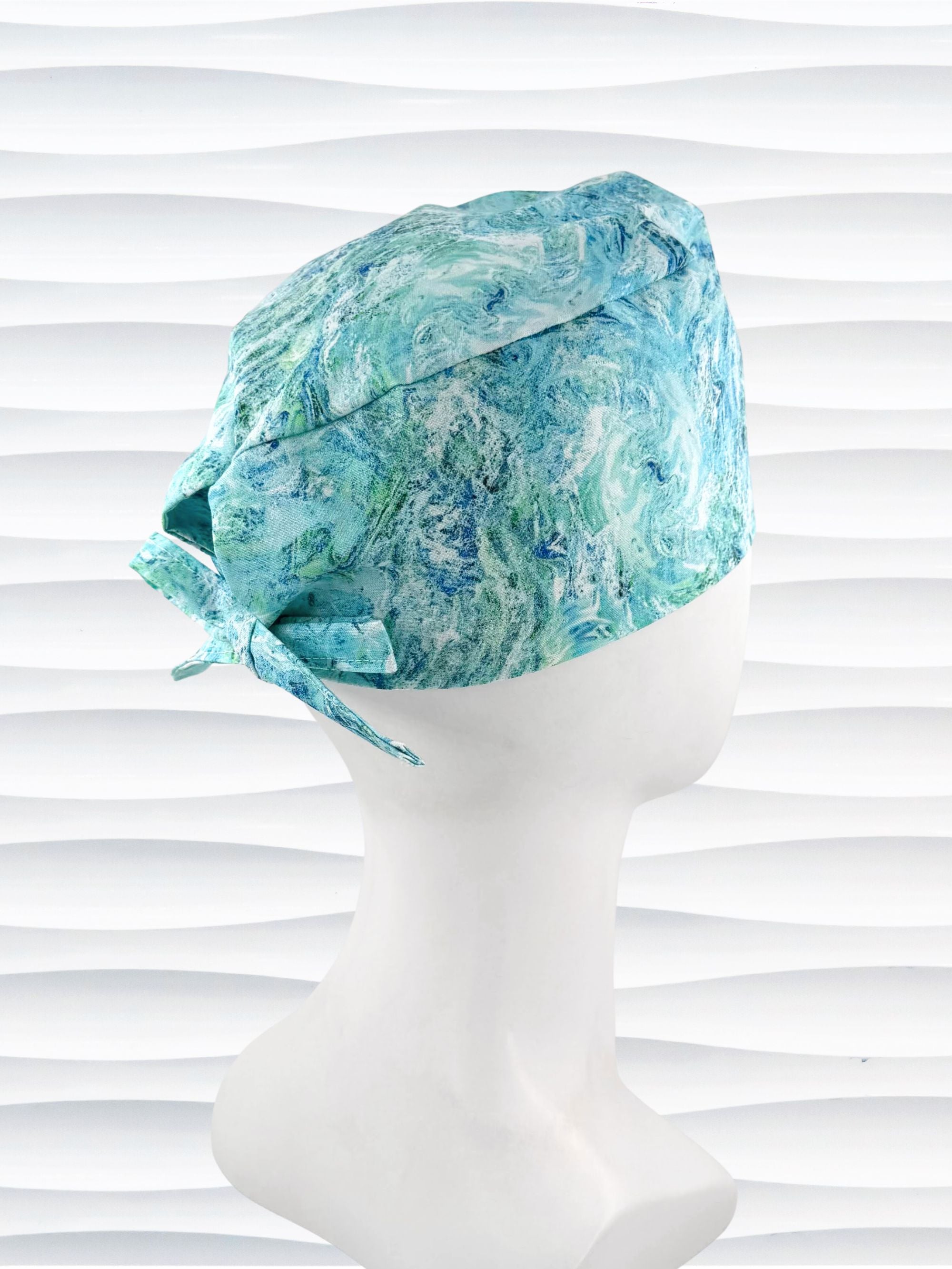 Turquoise and white marble abstract mens surgical scrub cap by JensCaps displayed on mannequin head