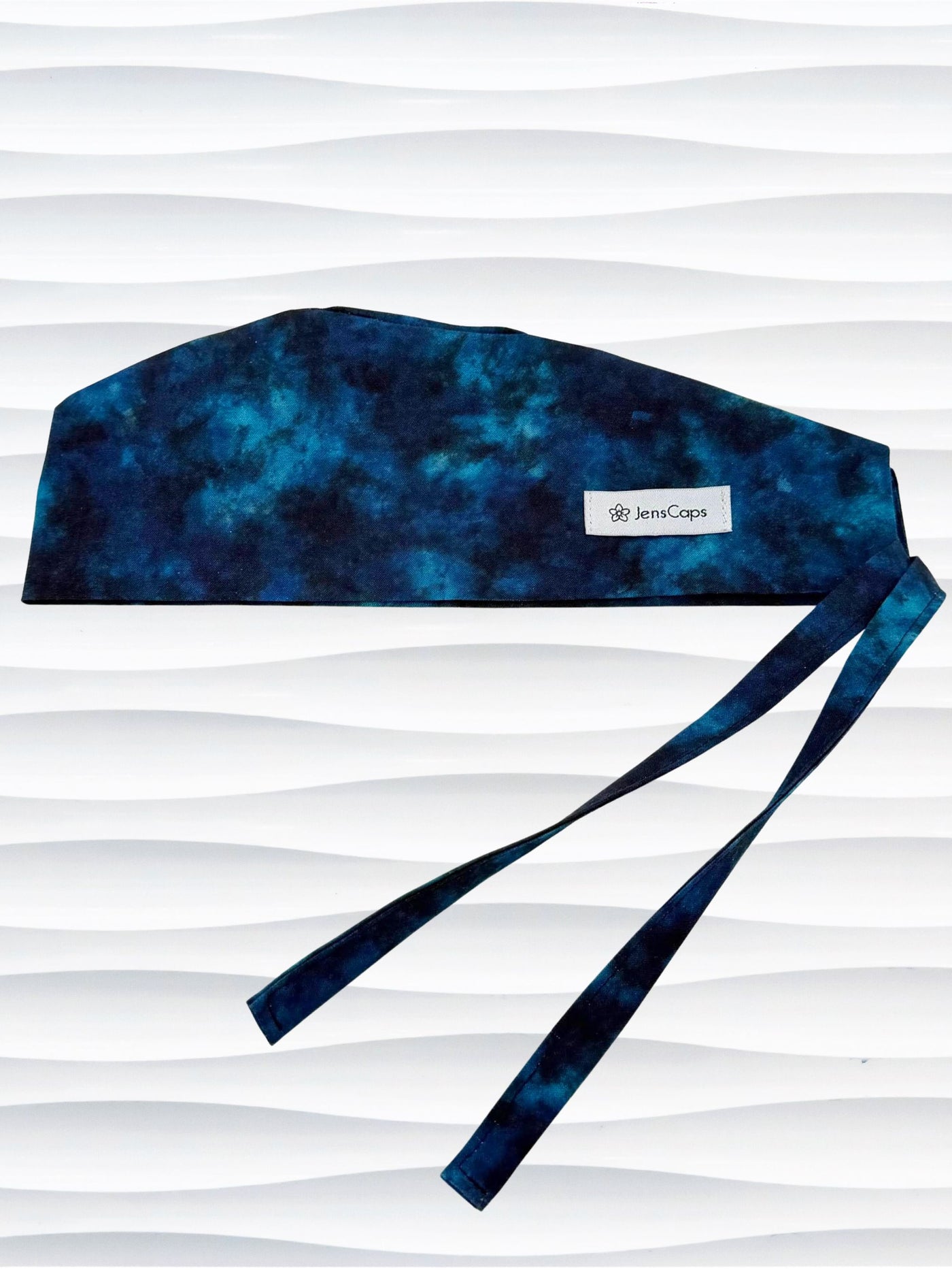 Surgeon style surgical scrub cap by JensCaps with dark blues and turquoise displayed on a mannequin head
