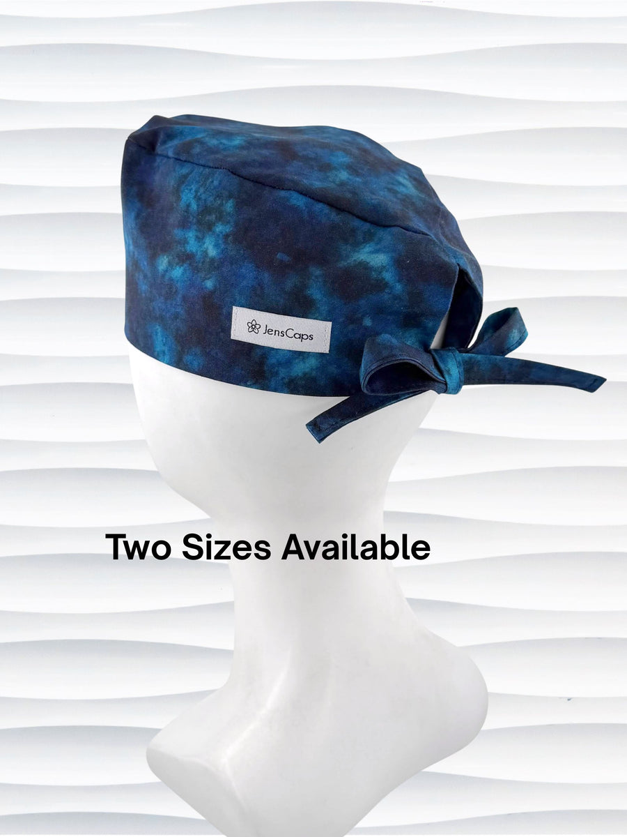 Surgeon style surgical scrub cap by JensCaps with dark blues and turquoise displayed on a mannequin head
