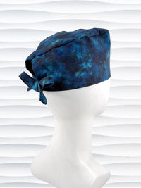 Surgeon style surgical scrub cap by JensCaps with dark blues and turquoise displayed on a mannequin head
