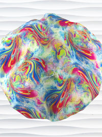 Bouffant style surgical scrub cap by JensCaps with an abstract marbled swirl print in blue, pink, yellow, and green, and displayed on a white mannequin head.