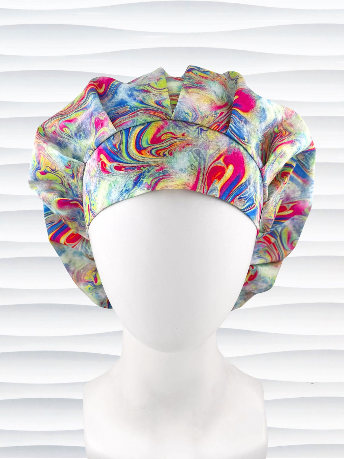 Bouffant style surgical scrub cap by JensCaps with an abstract marbled swirl print in blue, pink, yellow, and green, and displayed on a white mannequin head.