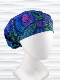 Bouffant style surgical scrub cap by JensCaps with an allover floral pattern in dark blue, purple, emerald, and turquoise and displayed on a mannequin head.