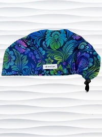 Euro Pixie style surgical scrub cap by JensCaps with an allover floral pattern in dark blue, purple, emerald, and turquoise.