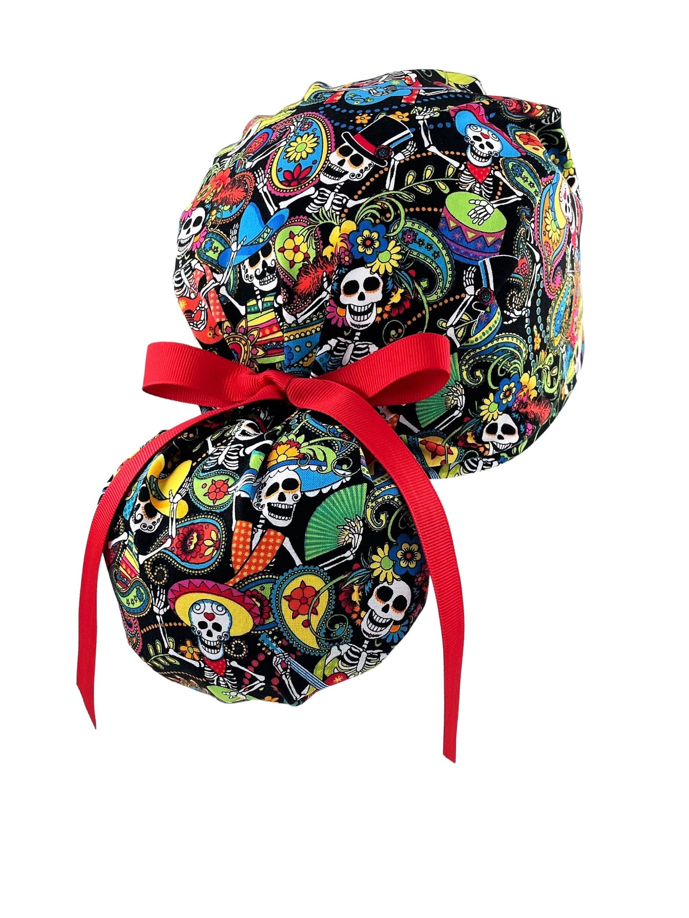Ponytail scrub cap hat with day of the dead in bright colors on black cotton fabric and finished with grosgrain ribbon ties.
