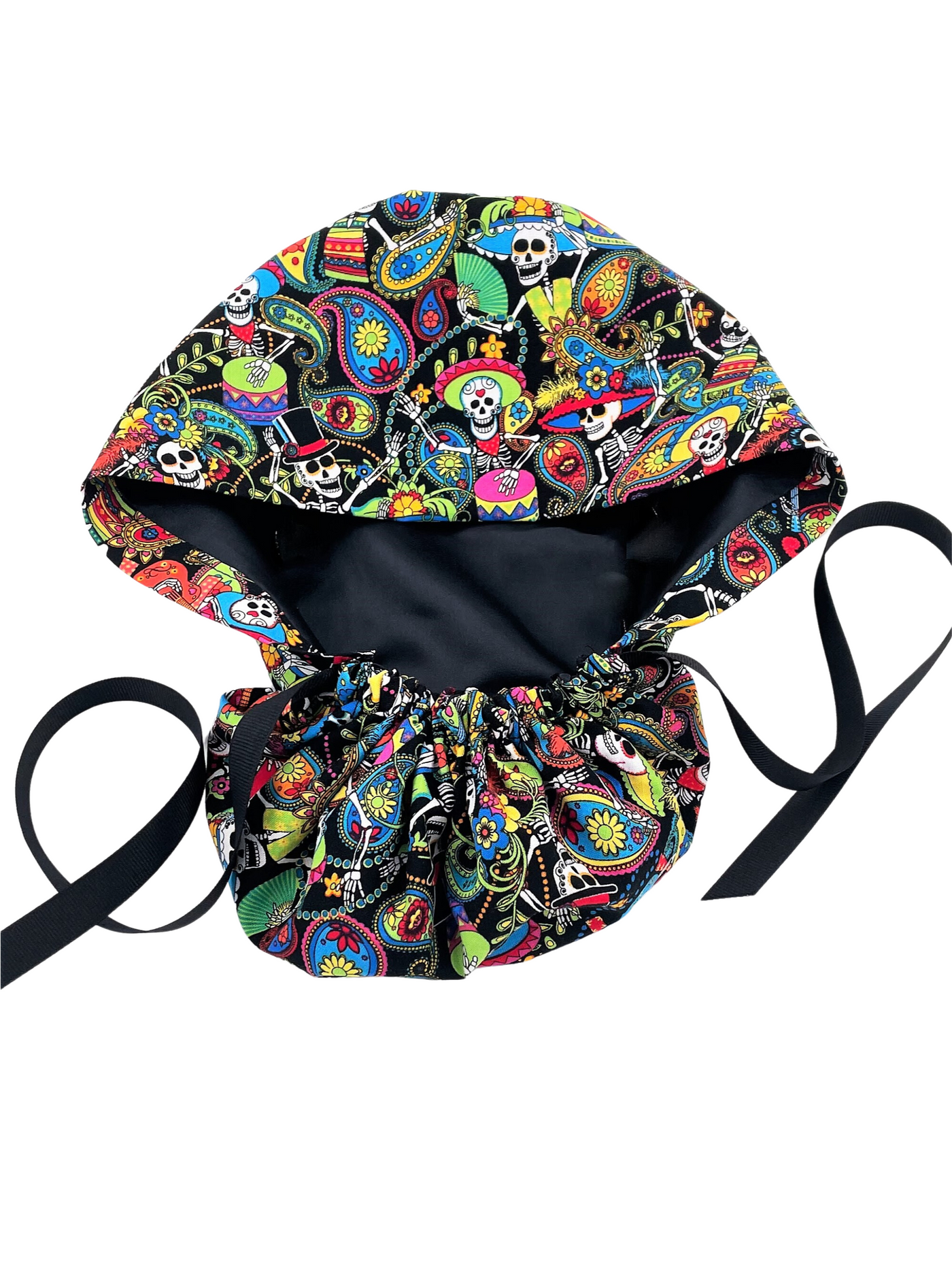Ponytail scrub cap hat with day of the dead in bright colors on black cotton fabric and finished with grosgrain ribbon ties.