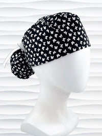 Ponytail style scrub cap hat with white butterflies on black cotton fabric.