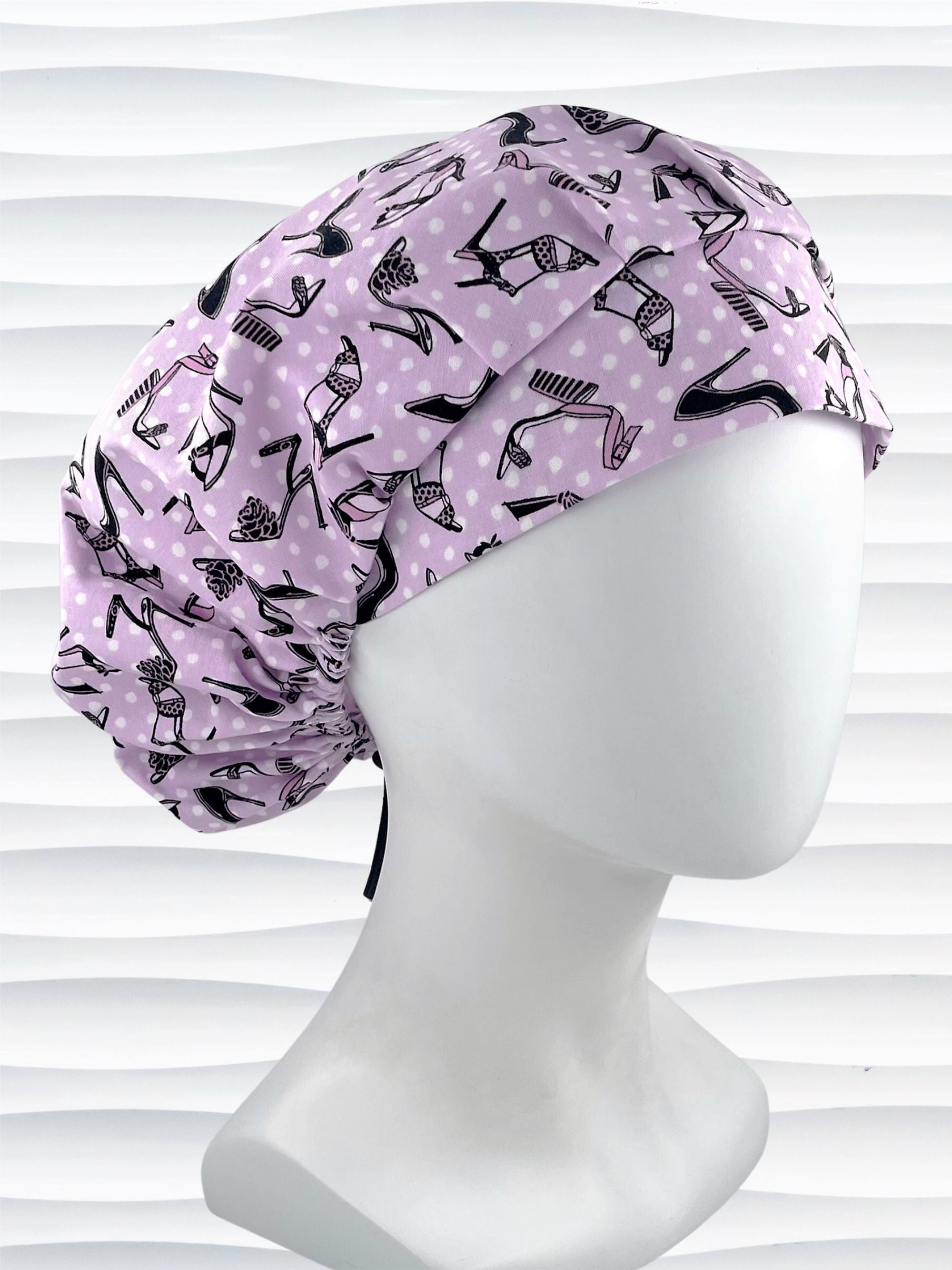 Bouffant style scrub cap hat with pink and black high heel shoes and white dots on pink cotton fabric.
