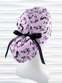 Ponytail style scrub cap hat with pink and black high heel shoes and white dots on pink cotton fabric.
