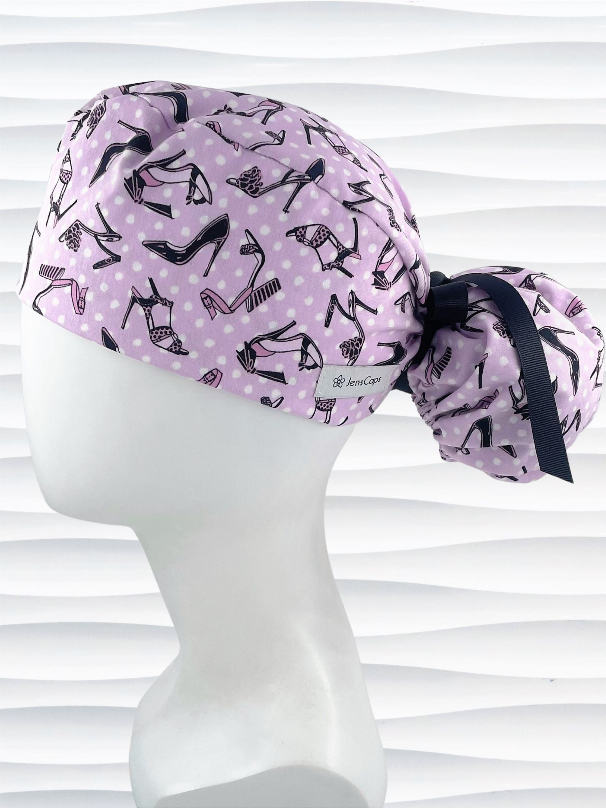 Ponytail style scrub cap hat with pink and black high heel shoes and white dots on pink cotton fabric.