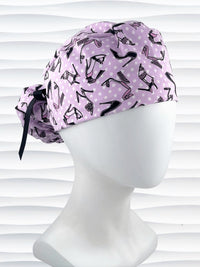 Ponytail style scrub cap hat with pink and black high heel shoes and white dots on pink cotton fabric.