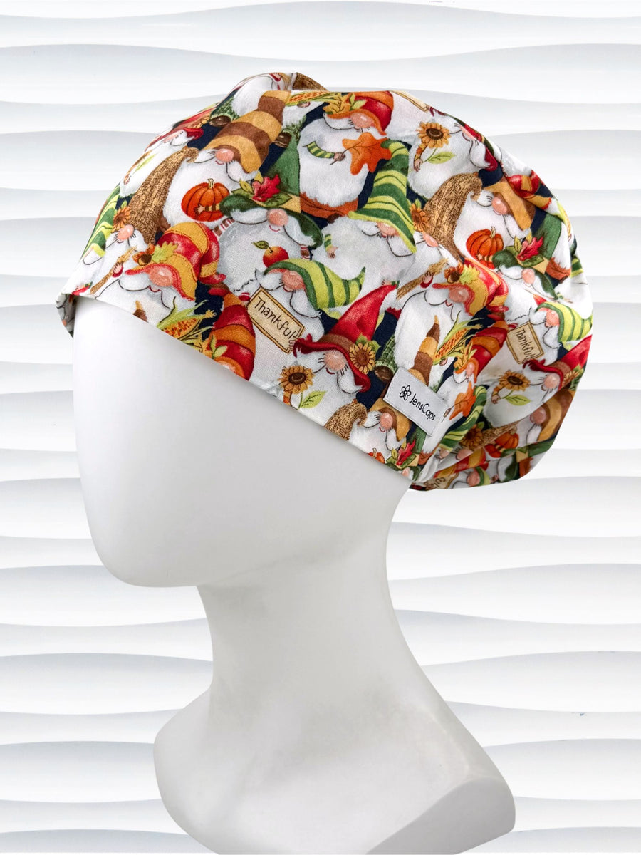 Euro Pony style surgical scrub cap with gnomes in fall colors holding sunflowers and signs that say thankful and displayed on a mannequin head.