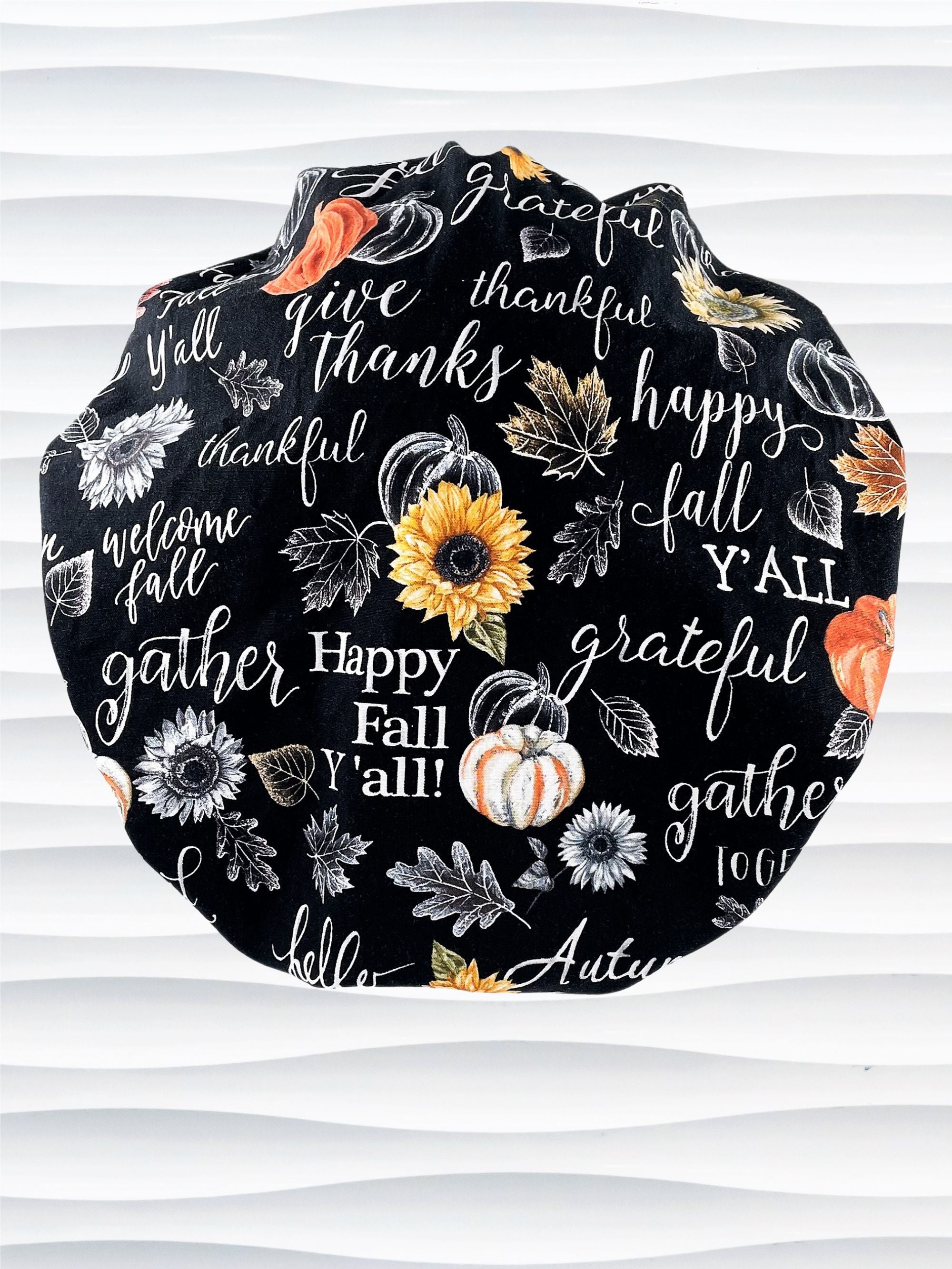 Bouffant style surgical scrub cap hat with pumpkins, sunflowers, and words about Thanksgiving on black cotton fabric. Happy Fall Y'all